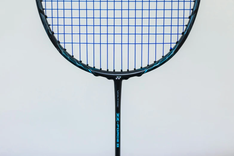 a blue tennis racket in front of a white background