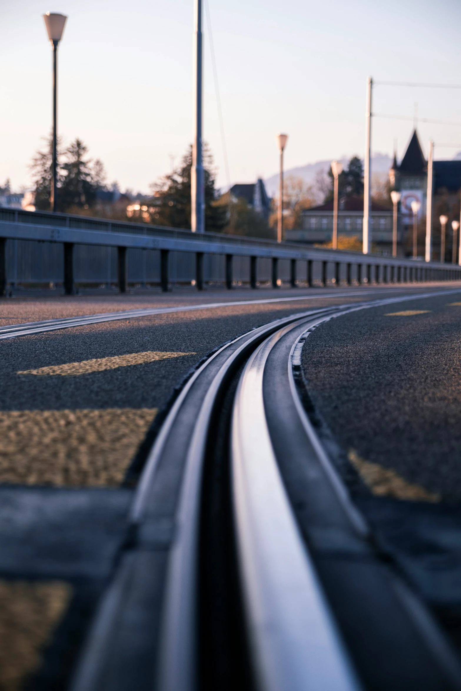 close up view of a train track stretching across an empty roadway