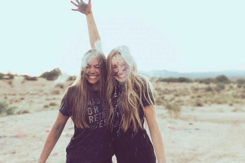 two girls with frost on their faces are posing for a picture