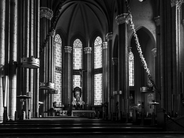 the inside of a cathedral looking toward a cross