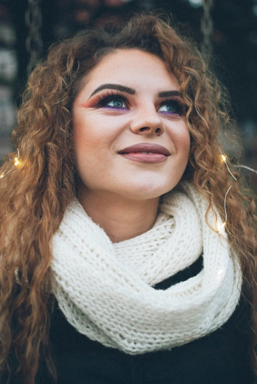 a close up of a person wearing a scarf