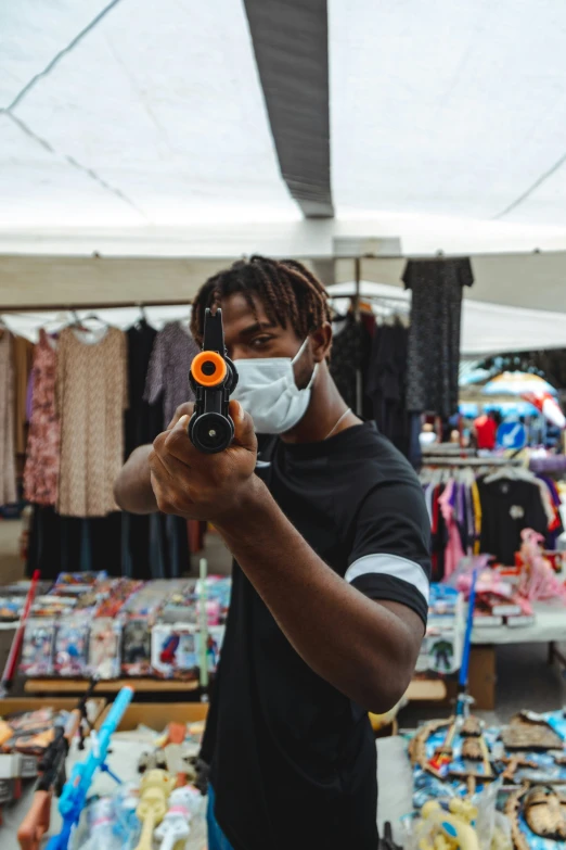 man with protective mask on taking pictures with his camera