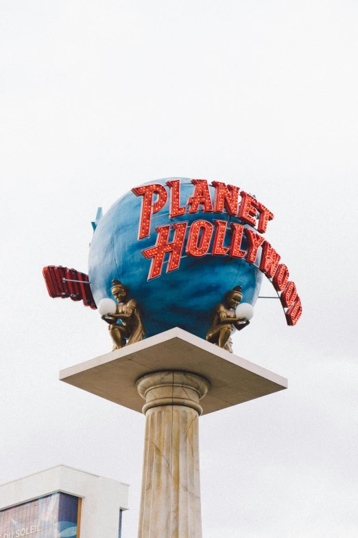 a blue and red sign that reads planet hollywood