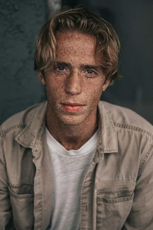 a man looking into the camera with dirt all over his face