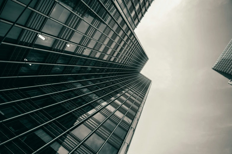 two tall buildings stand against the blue sky