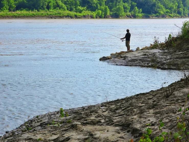 there is a man holding onto a fishing pole