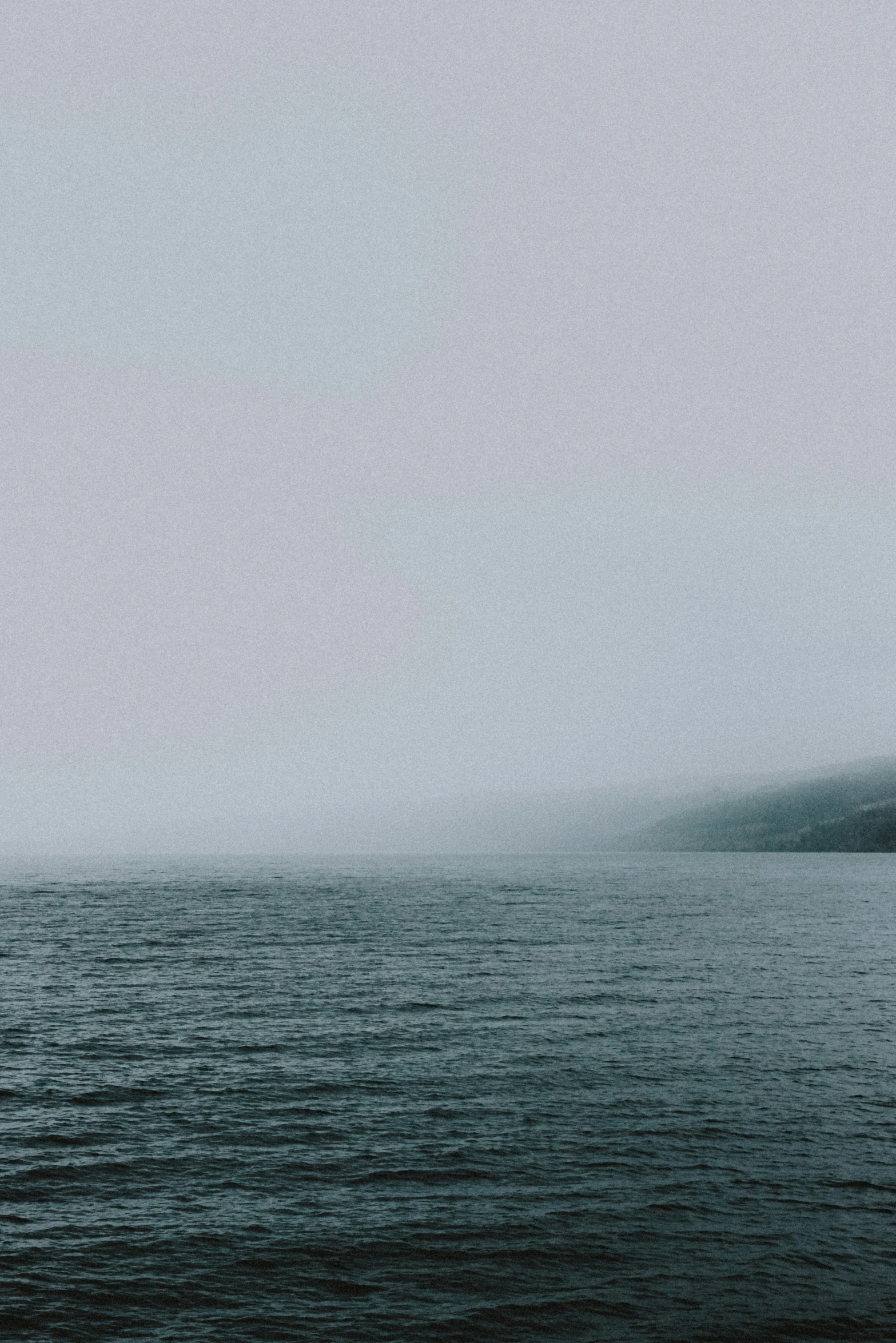 black and white pograph of water in foggy weather