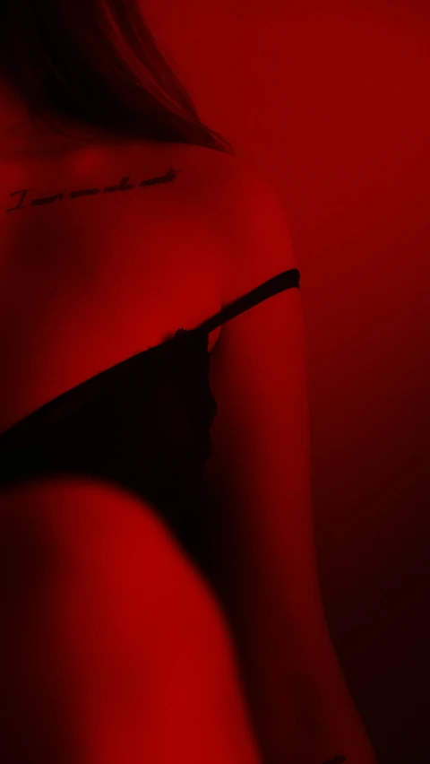 the image of a woman with black lingerie and red light