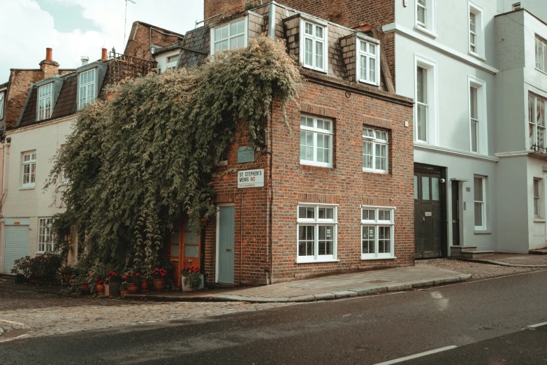 a very tall brick building with a small courtyard next to it