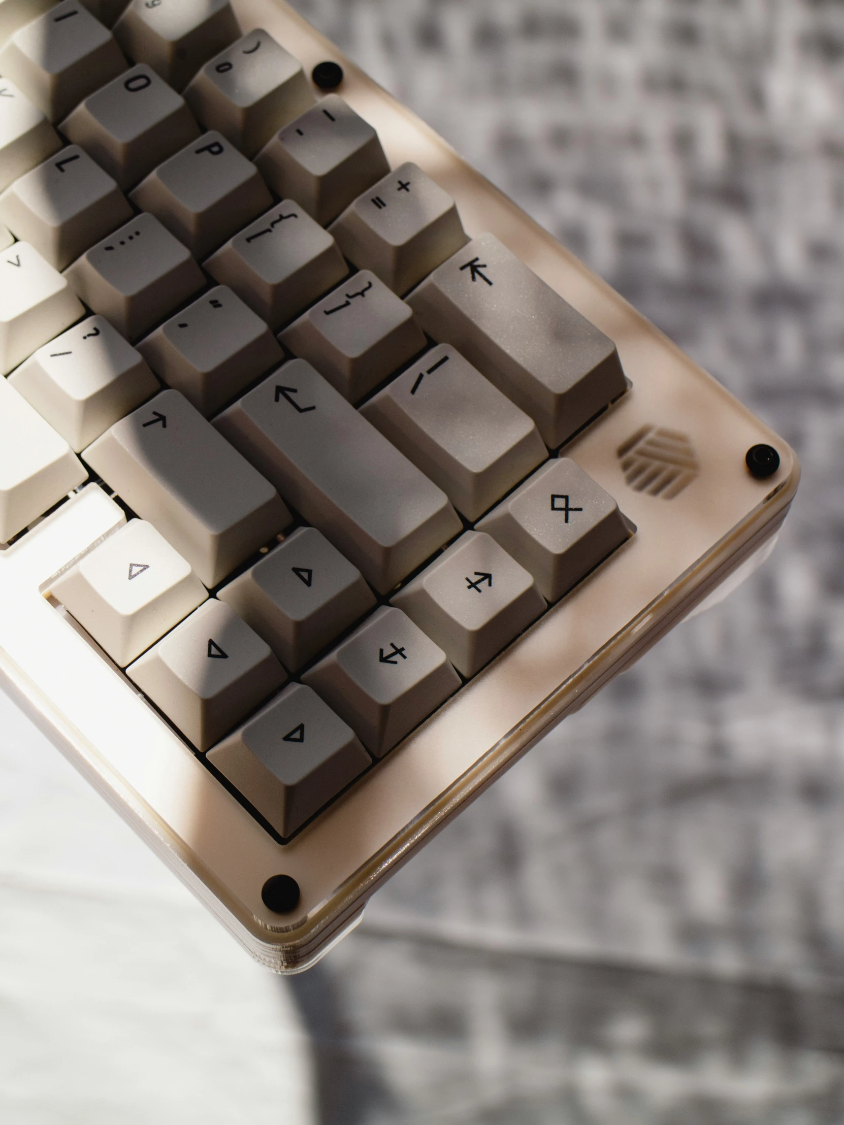 a brown and silver computer keyboard on top of a desk