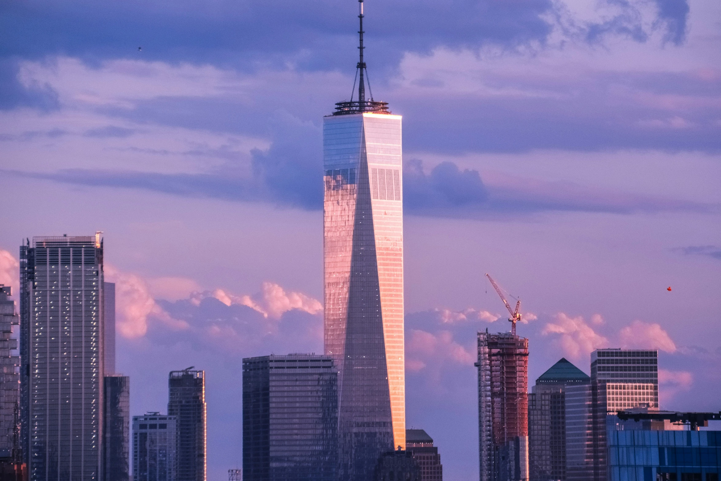 the view of new york skyline with one world trade center in the foreground