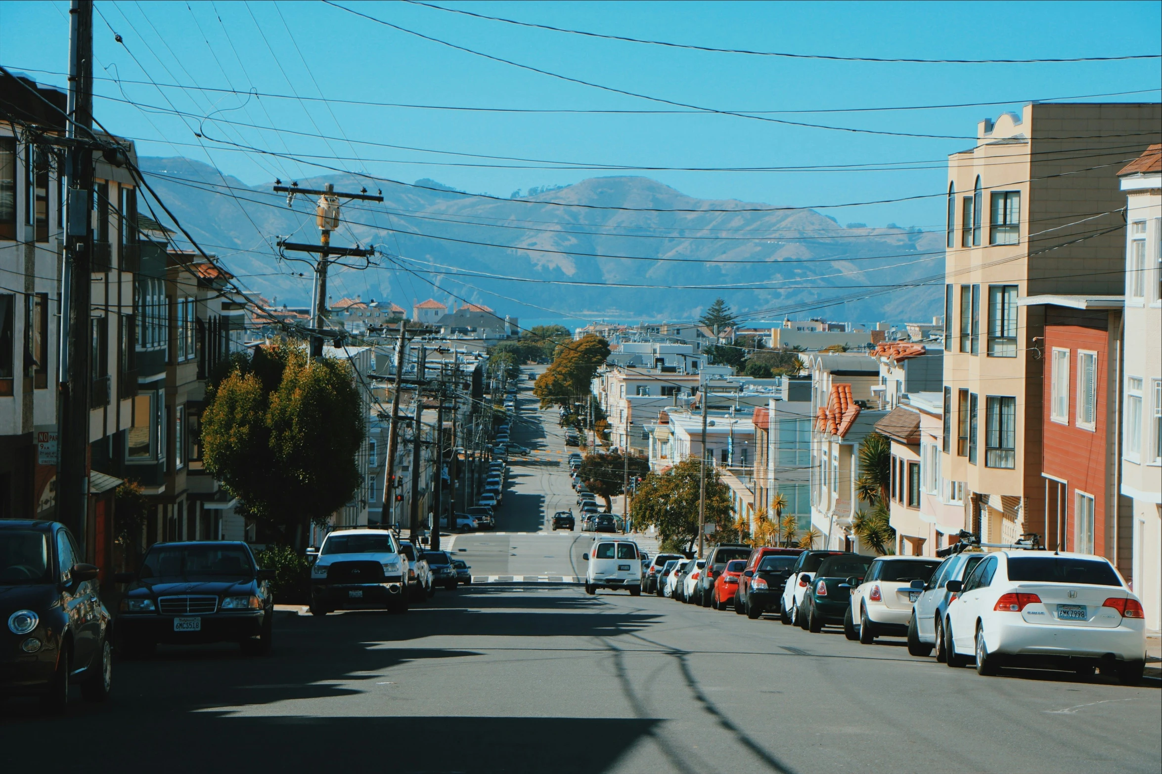 some cars are parked on the side of the street