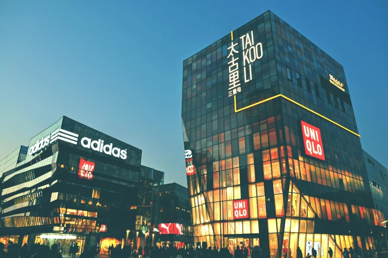 an assortment of tall buildings with lit up windows