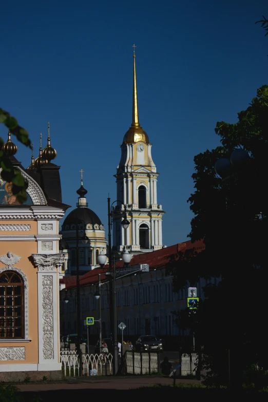 buildings are standing near a sidewalk in the evening