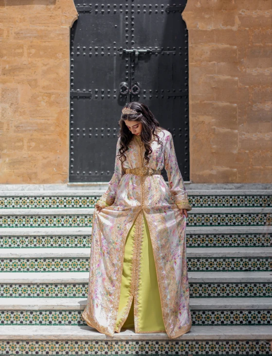 woman in colorful dress standing on stairs by doorway