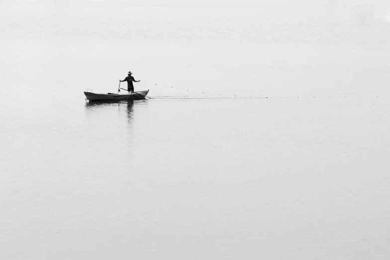 a man is rowing a canoe across the water