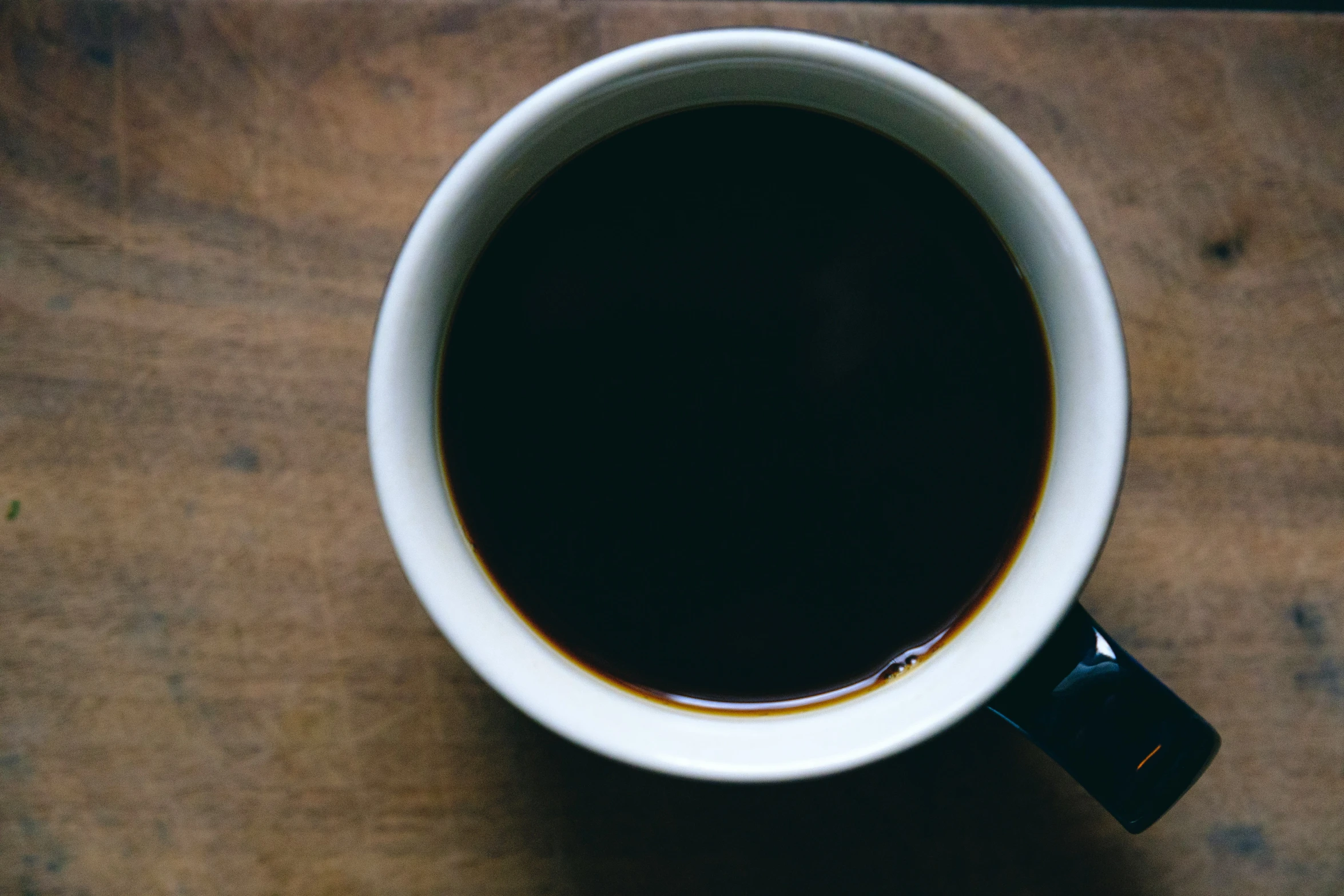 a coffee cup on a wood table