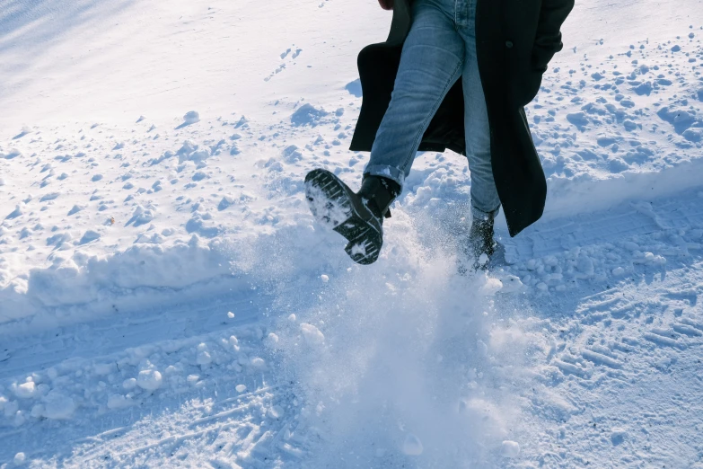 someone riding their snowboard on top of some very snowy ground