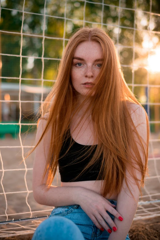 a redhead haired girl with long hair and piercing
