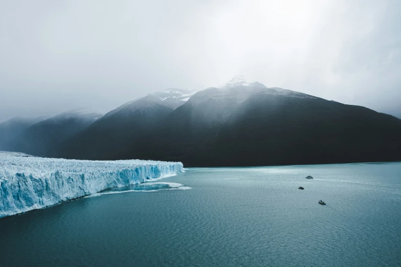 a large iceberg is partially frozen next to a body of water