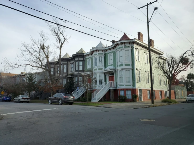 street with three story buildings and parking lot near intersection