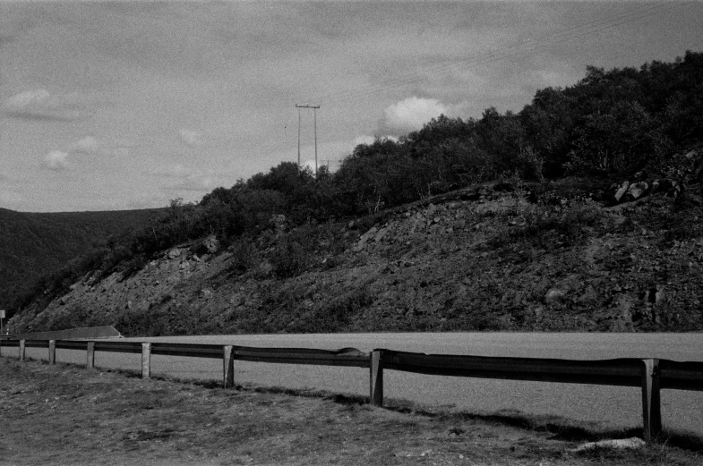 a line of road signs on the side of a hill