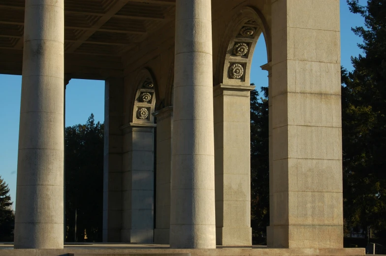 an outdoor area with pillars and clocks