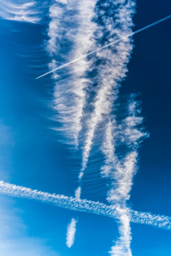 two contrails in the air near each other