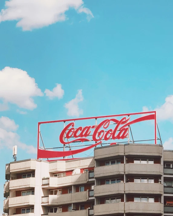 the coca cola sign on top of the building
