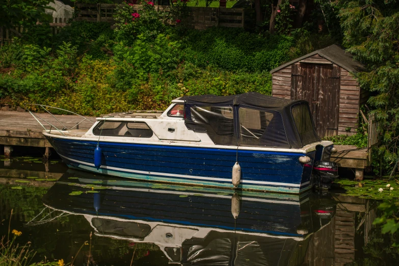 a boat docked with it's driver next to a dock