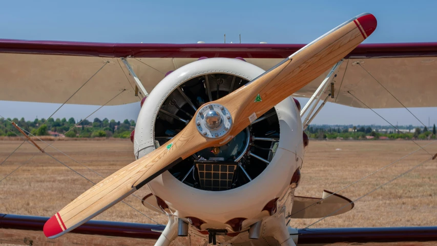 the propeller of an older airplane on the ground