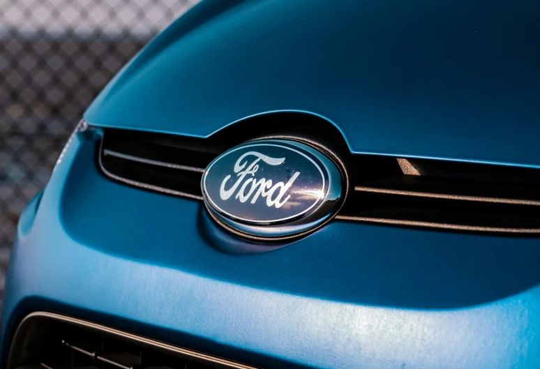 the emblem on the hood of a blue vehicle