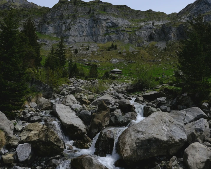 a river flowing down rocks with trees near by