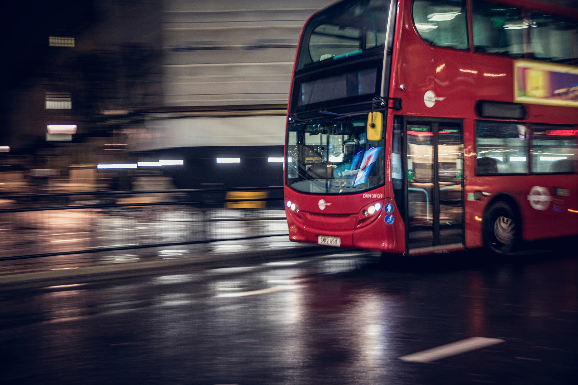 a city bus moving on the road at night