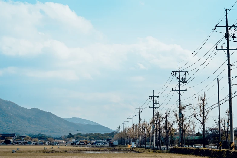 power lines stand out against a landscape that's hilly