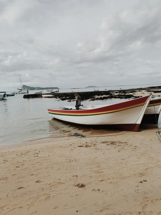 a canoe docked on the beach at low tide