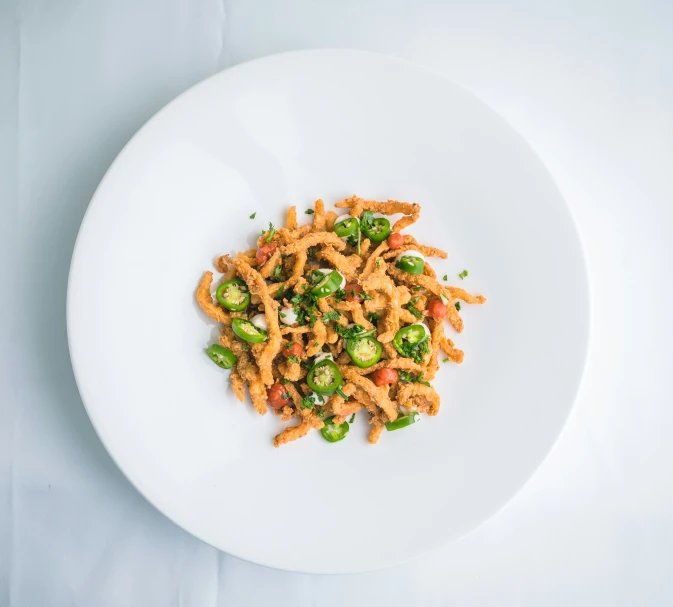 a small white plate with some noodles on it