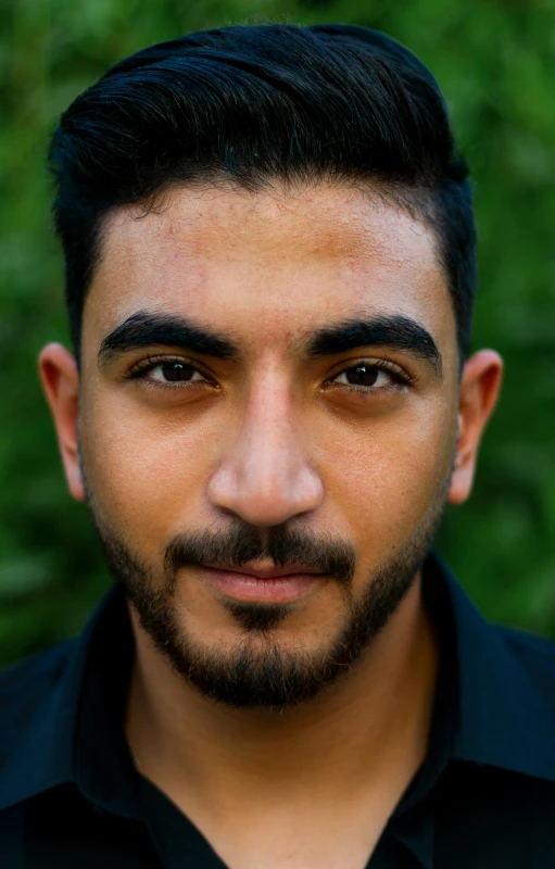 a man with short hair and beard posing for a picture