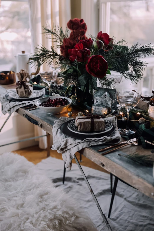 a dining table set with candles and flowers