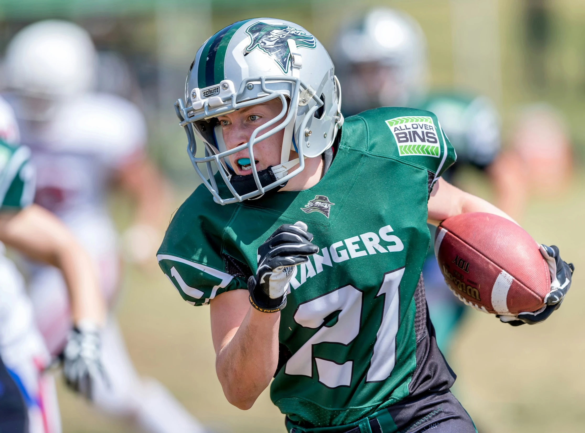 a man with a football is in the middle of a run