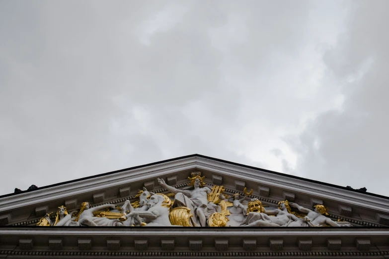 a very tall building with statues and a clock