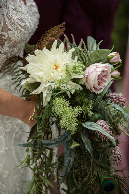 the brides bouquet is white and green