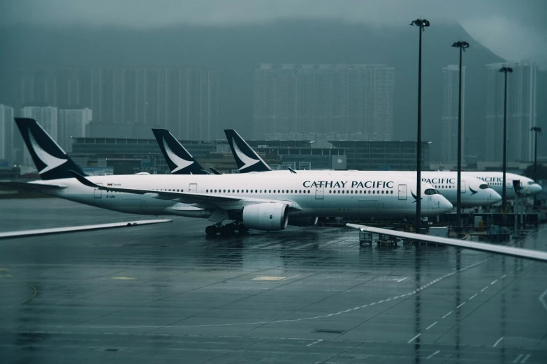 some planes are sitting parked at the gate