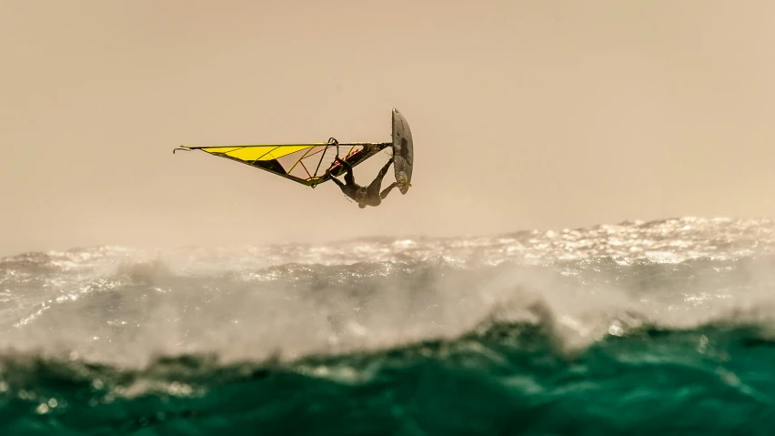 someone riding a parasail on an ocean wave