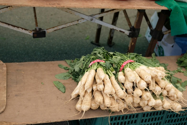 a bunch of radishes and other vegetables sit together