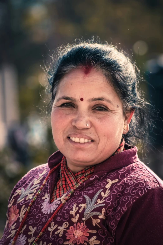 woman in ethnic clothing with head decoration and piercing