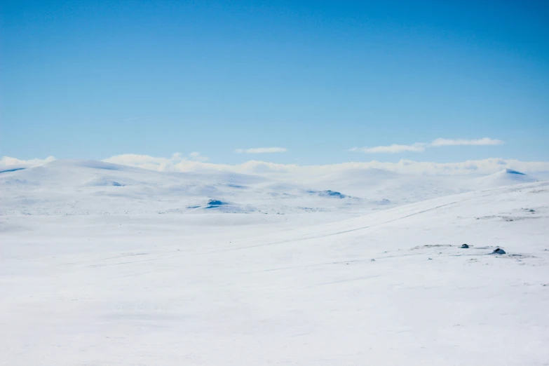 a person on skis going down a hill with a sky background