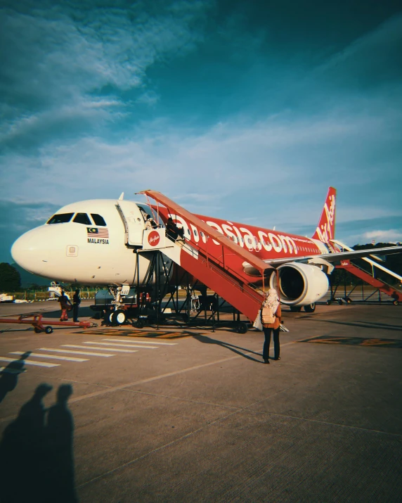 a person standing next to an airplane on a tarmac