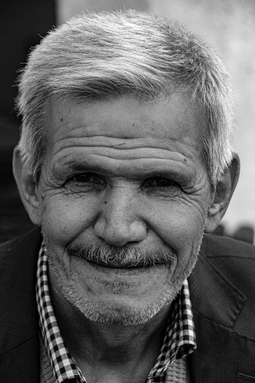 a black and white po of an old man with a smile