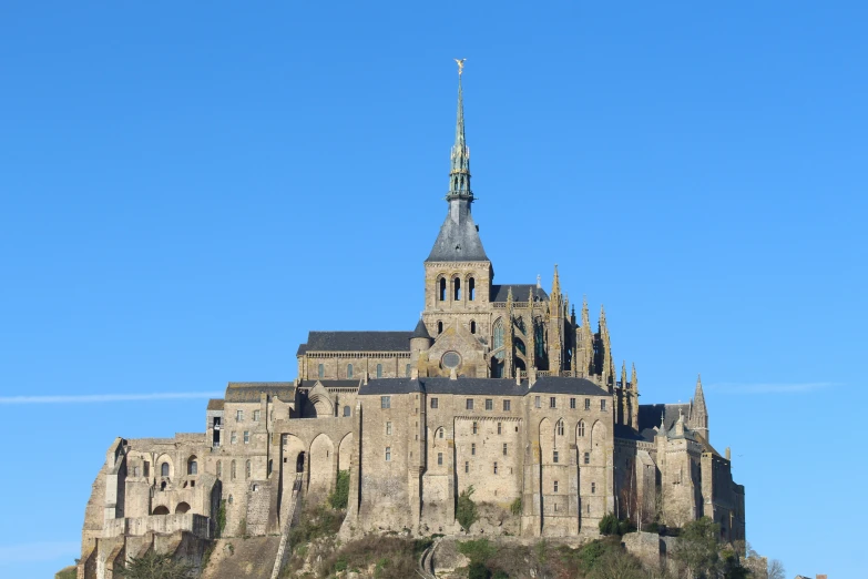 there is a large stone building on the side of the hill